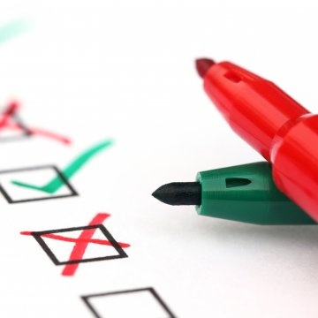 background check service best verispy peoplefinders red and green markers on white paper with boxes checked and x in boxes